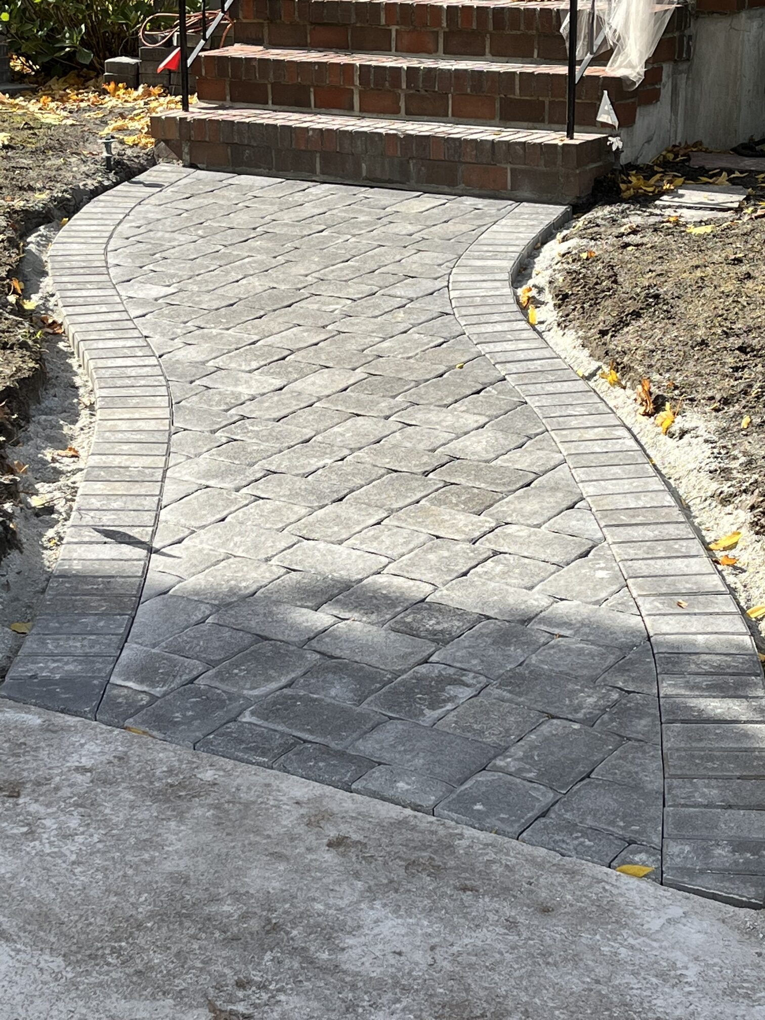 stone pathway leading to front steps of the house