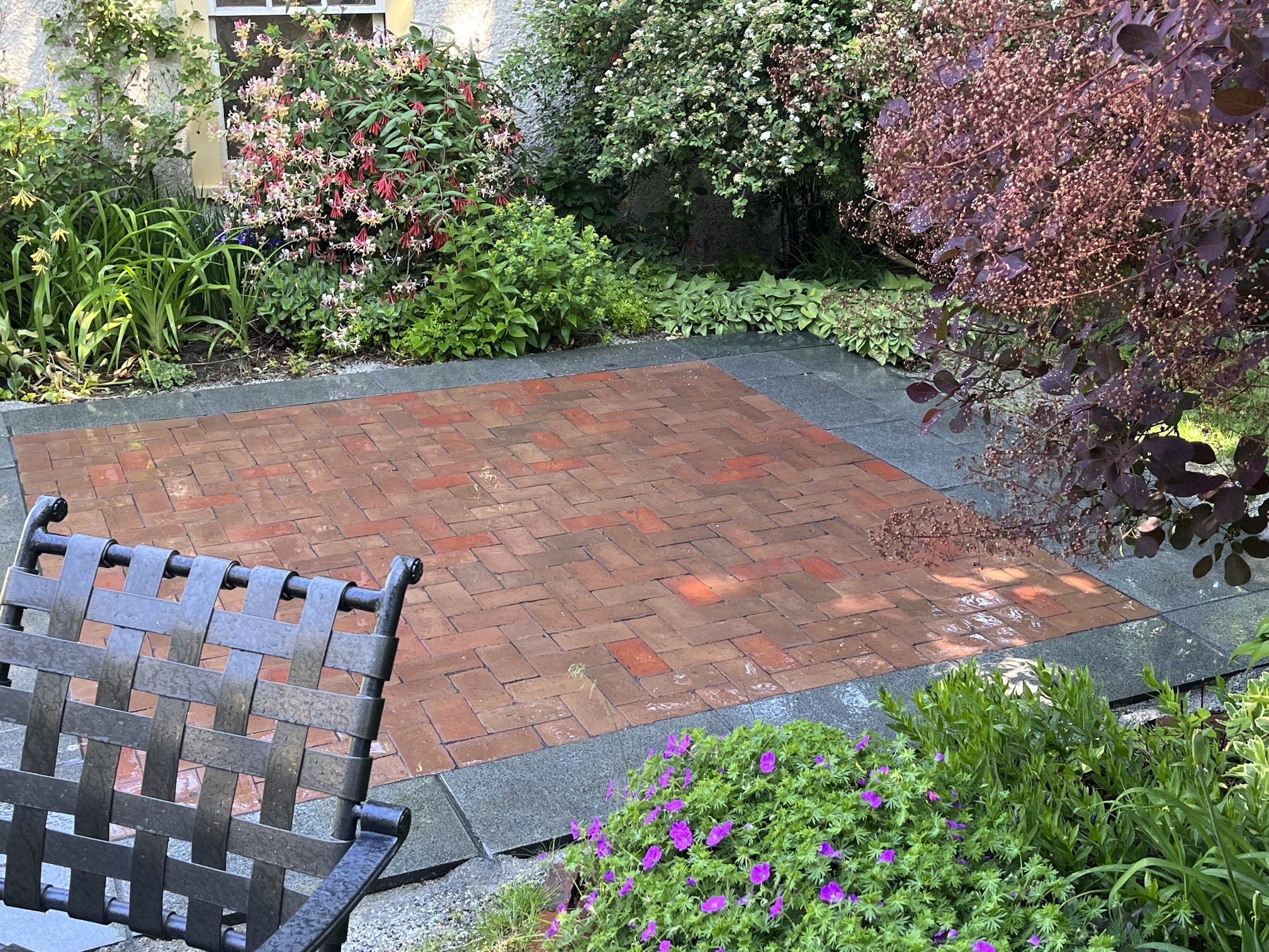 patio with brick and stone, corner of backyard garden