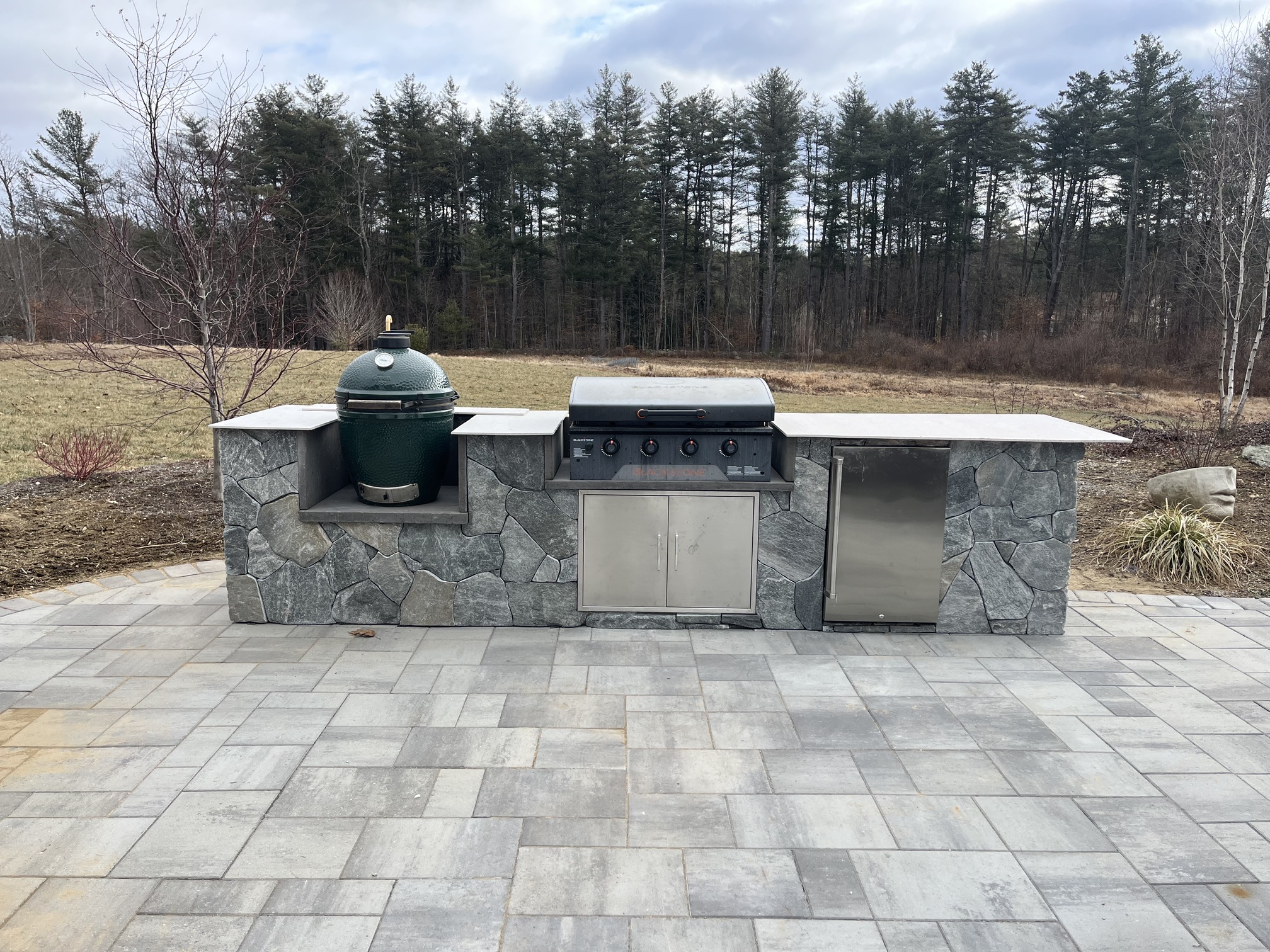 stone patio and outdoor grilling station with grill stoves and cooking surface